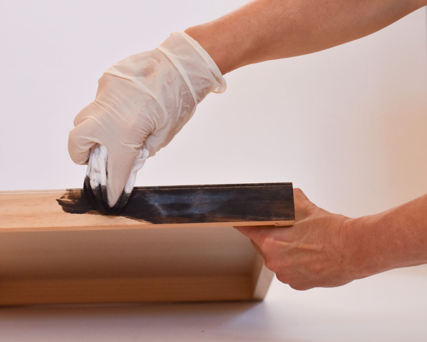 Applying stain to the sides of the cradled wood panel